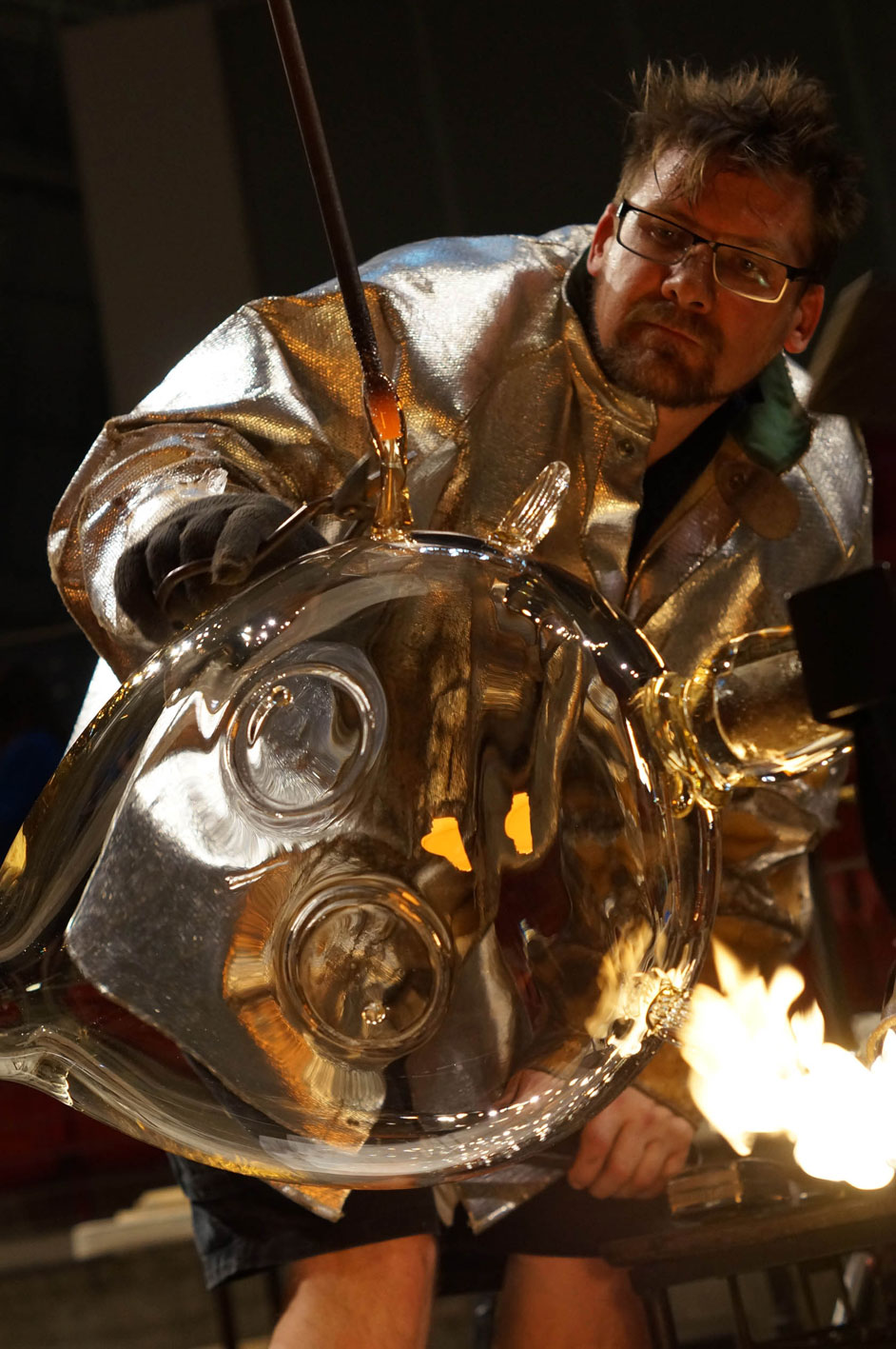 Tom Moore in his studio blowing glass. Image courtesy of the artist. 