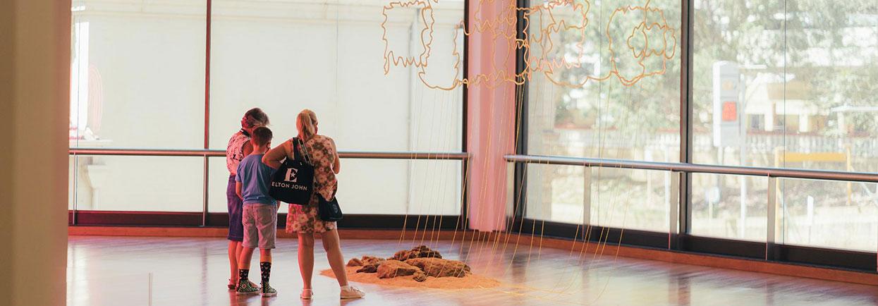 Balancing Act AGWA installation view, 2021. Ngarralja Tommy MayWarla, Flat Country 2021. Brass, aluminum, stone and soil, dimensions variable. The State Art Collection, The Art Gallery of Western Australia. Bequest of Bonice Tollafield. © Ngarralja Tommy May. Photo by Rift Photography.